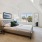 Large well lit bedroom with large windows and tan plush carpet.