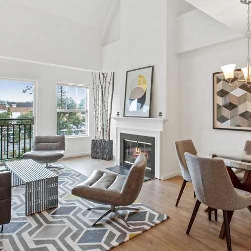 Spacious and well lit living room with adjacent dining area with access to the outdoor patio