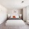 large bedroom with oversized windows, queen bed and seating area